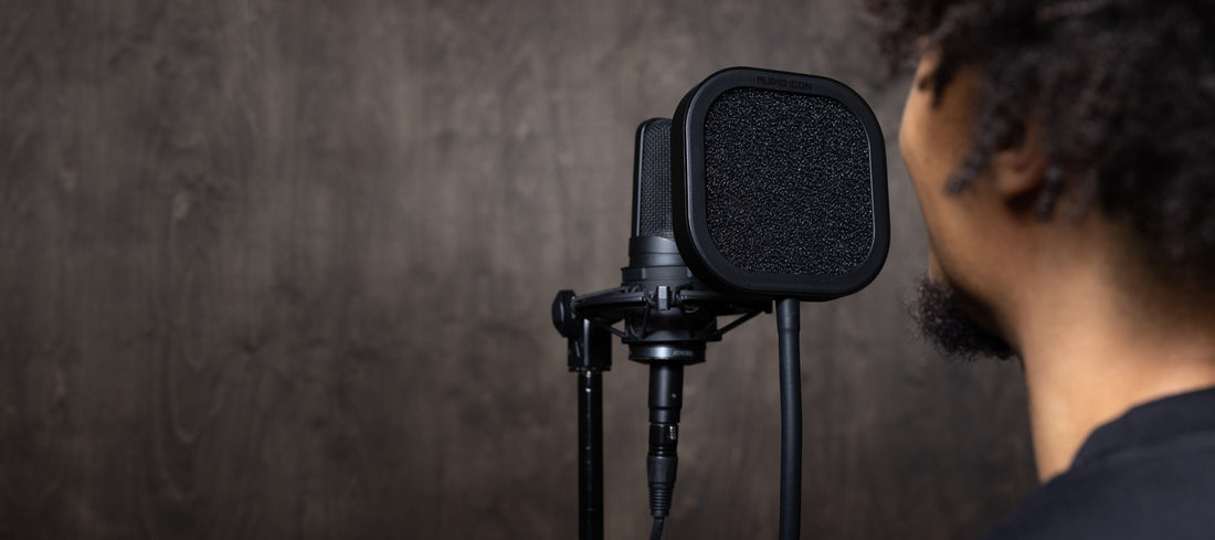 Artist recording at a studio microphone in a real Audio Icon studio environment.