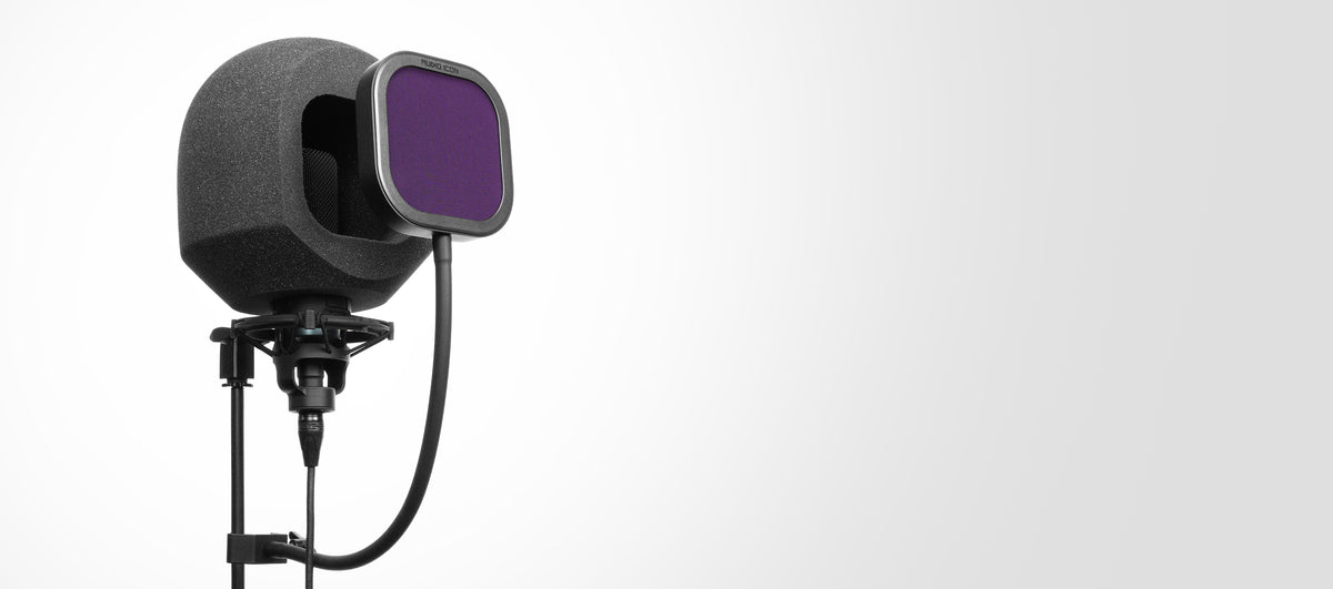 Microphone with SoundBox iso booth and a purple pop filter on a gray background