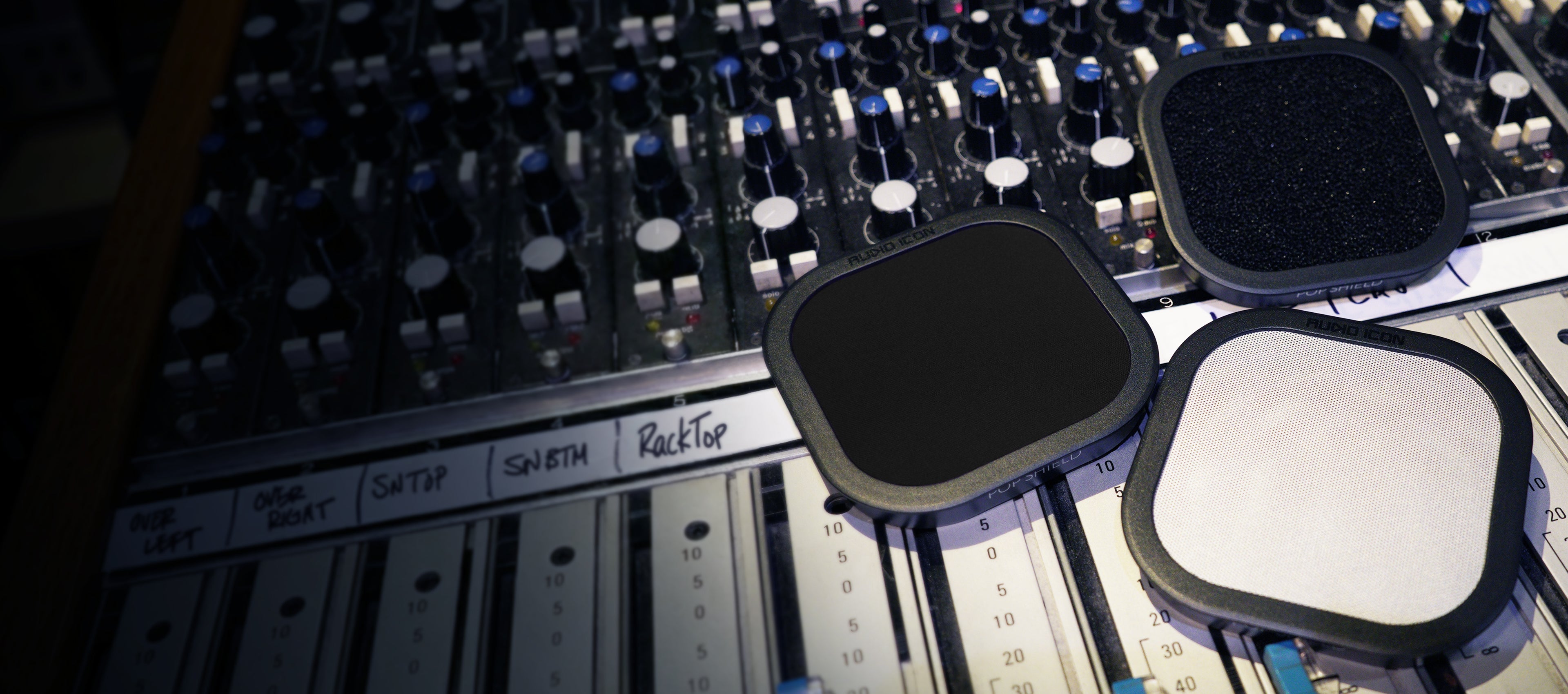Three Pop Shield Pop filters on a mixing console. Foam, Metal, and Black Pop Filter