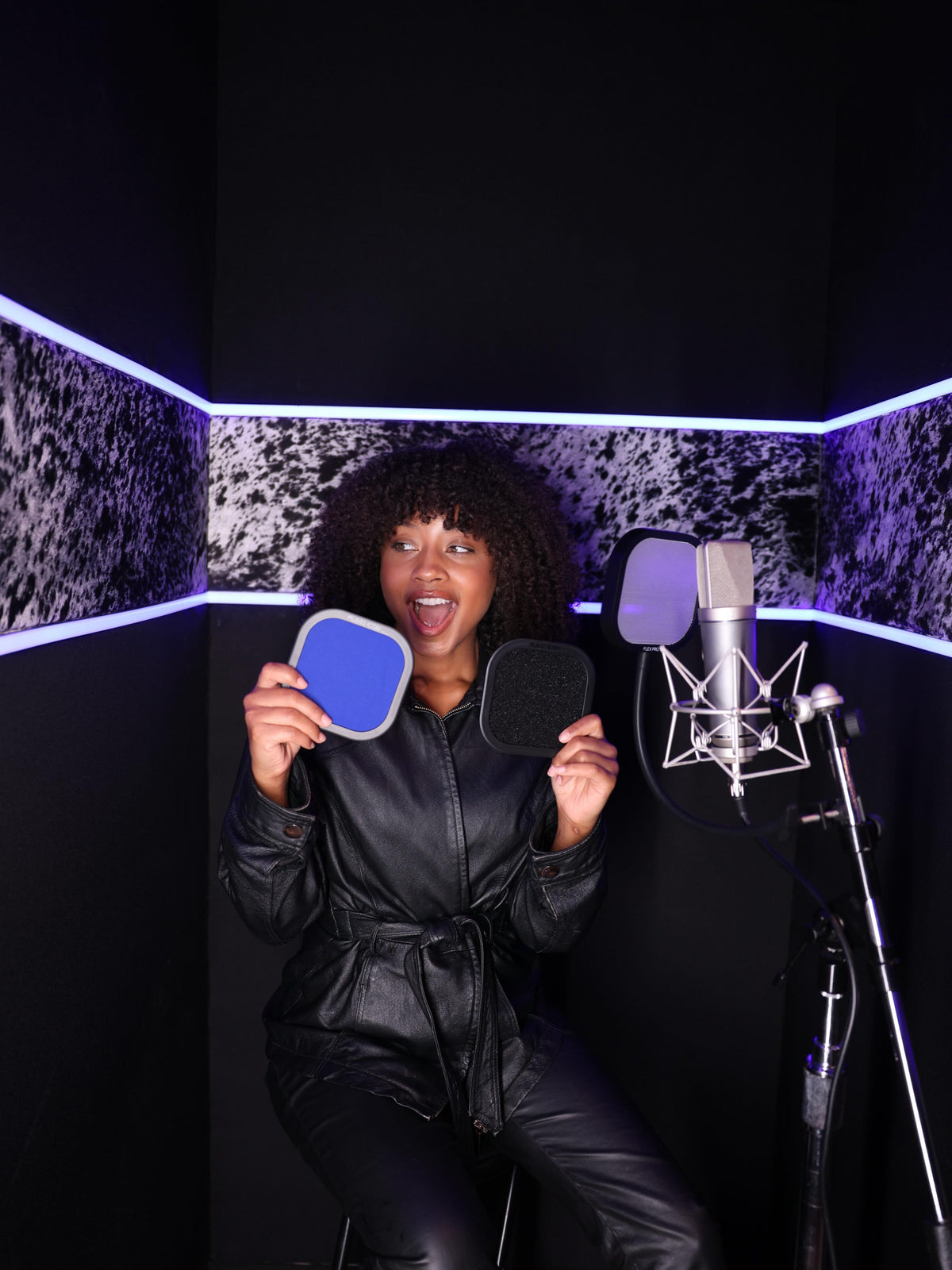 Audio creator demonstrating Audio Icon pop filters in a recording studio